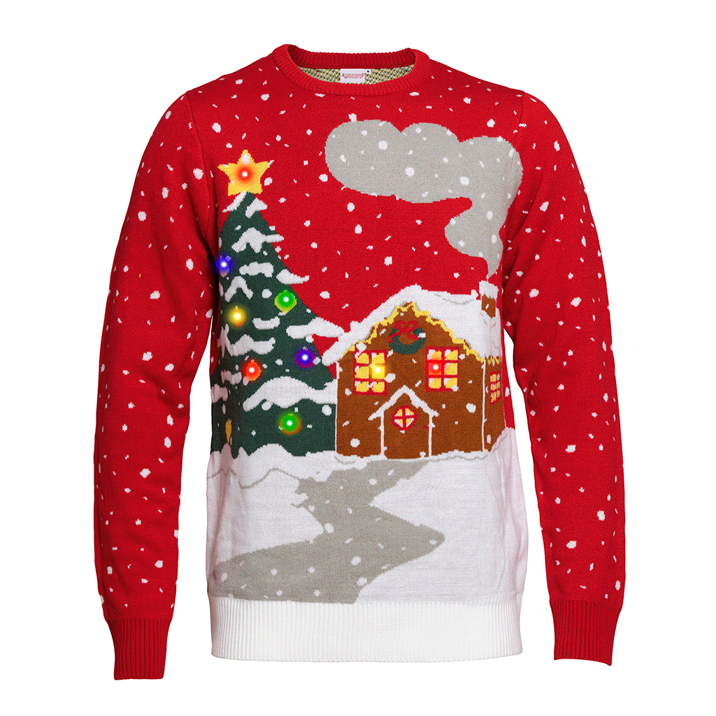 Un pull rouge de Noël avec une maison enneigée et un sapin de Noël illuminé.