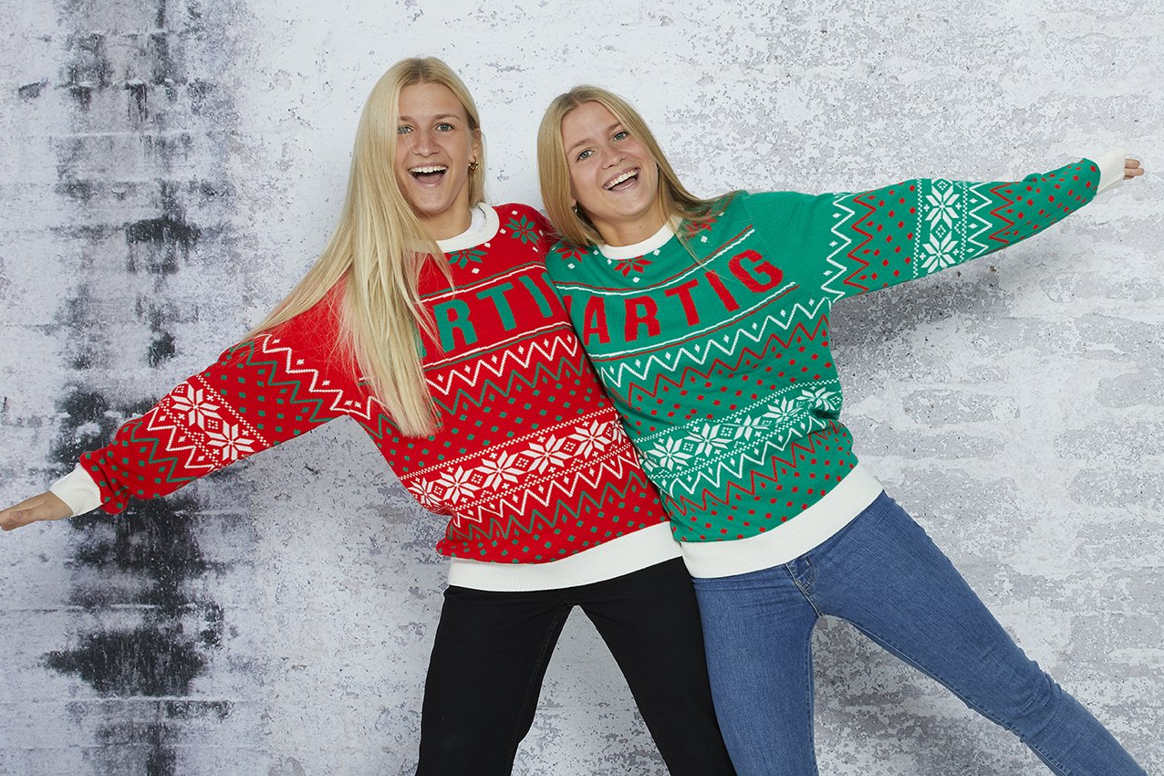 Deux femmes posant avec un pull rouge et vert.