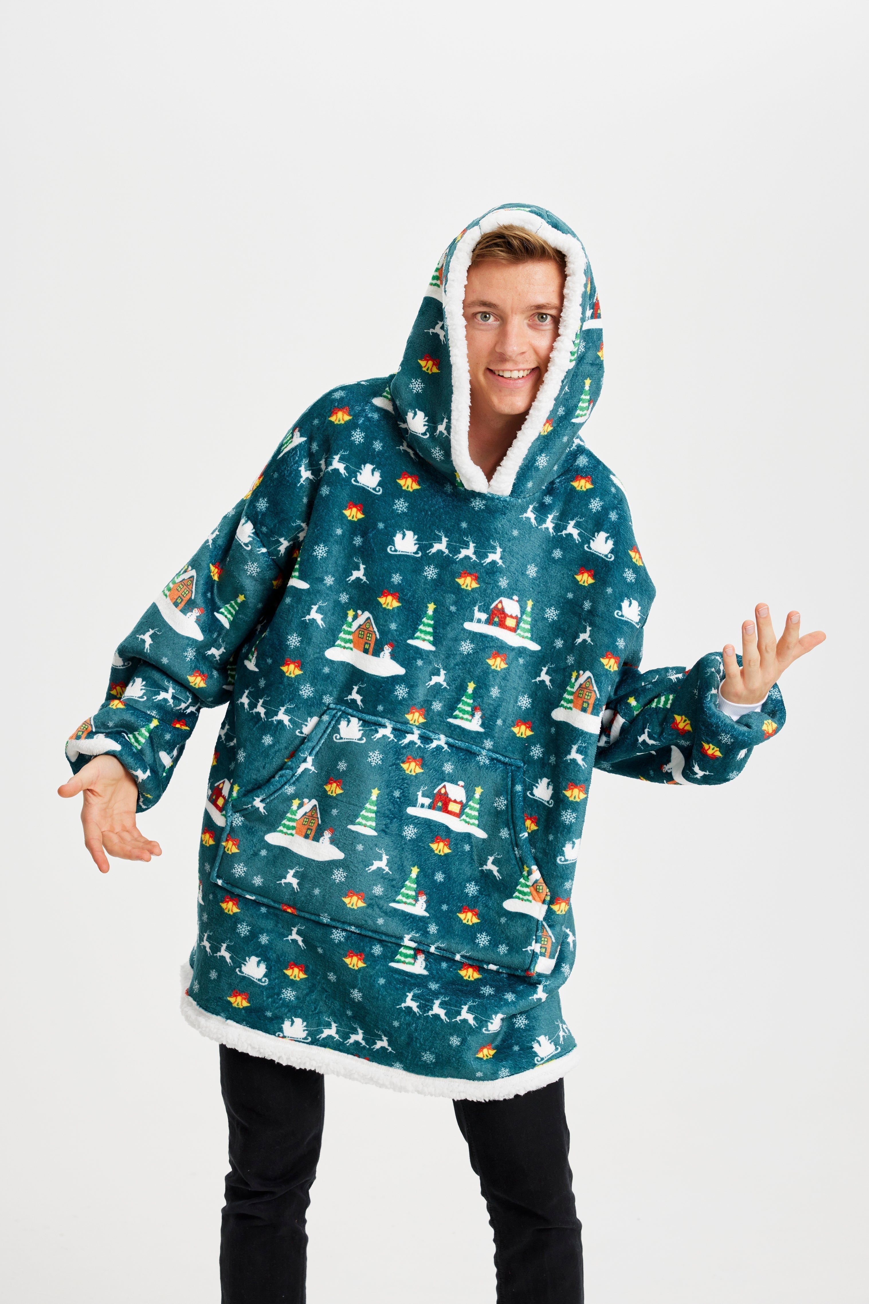 Un homme souriant portant un sweat à capuche vert à motifs de Noël.