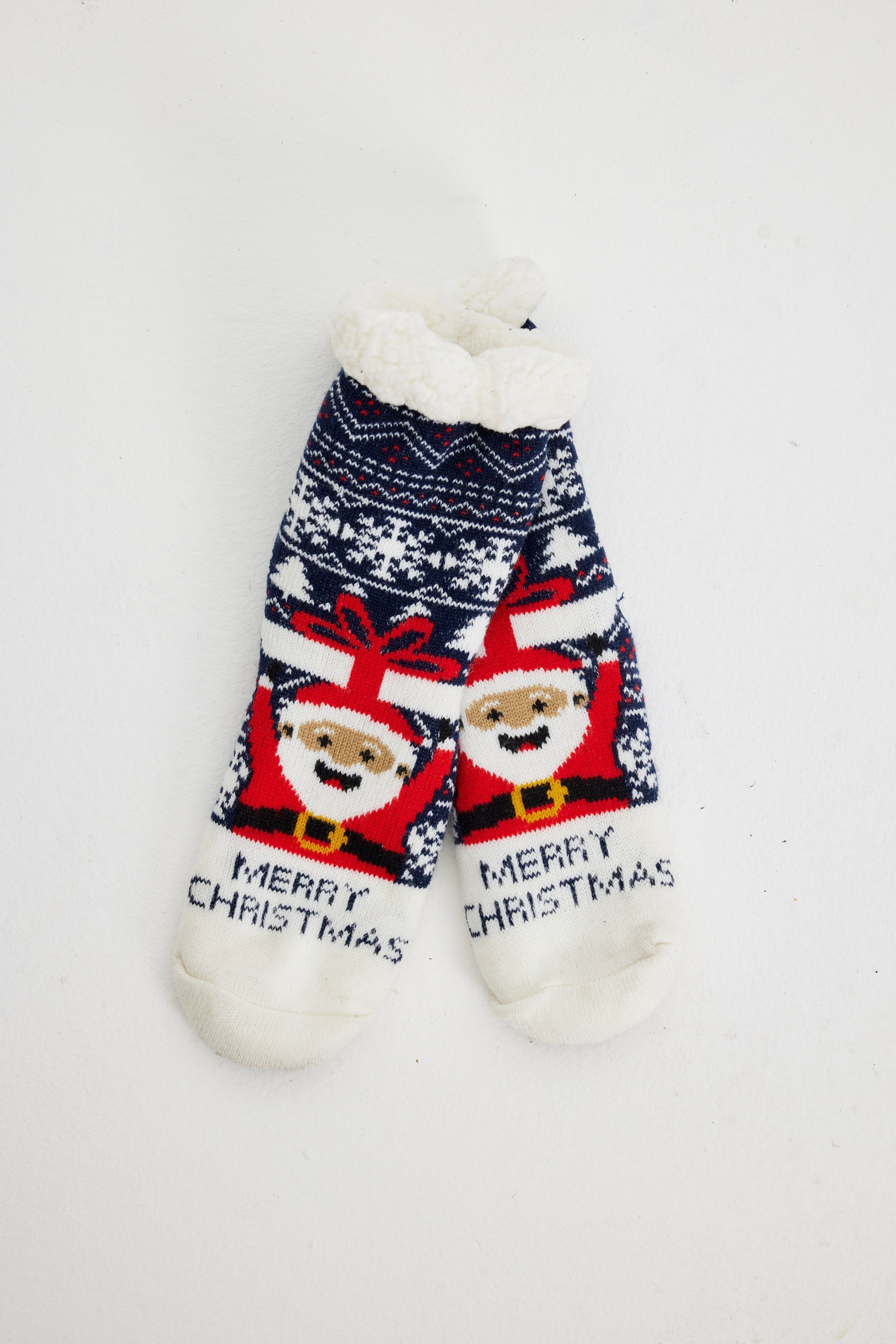 Une paire de chaussettes de Noël bleues avec un Père Noël dessus.