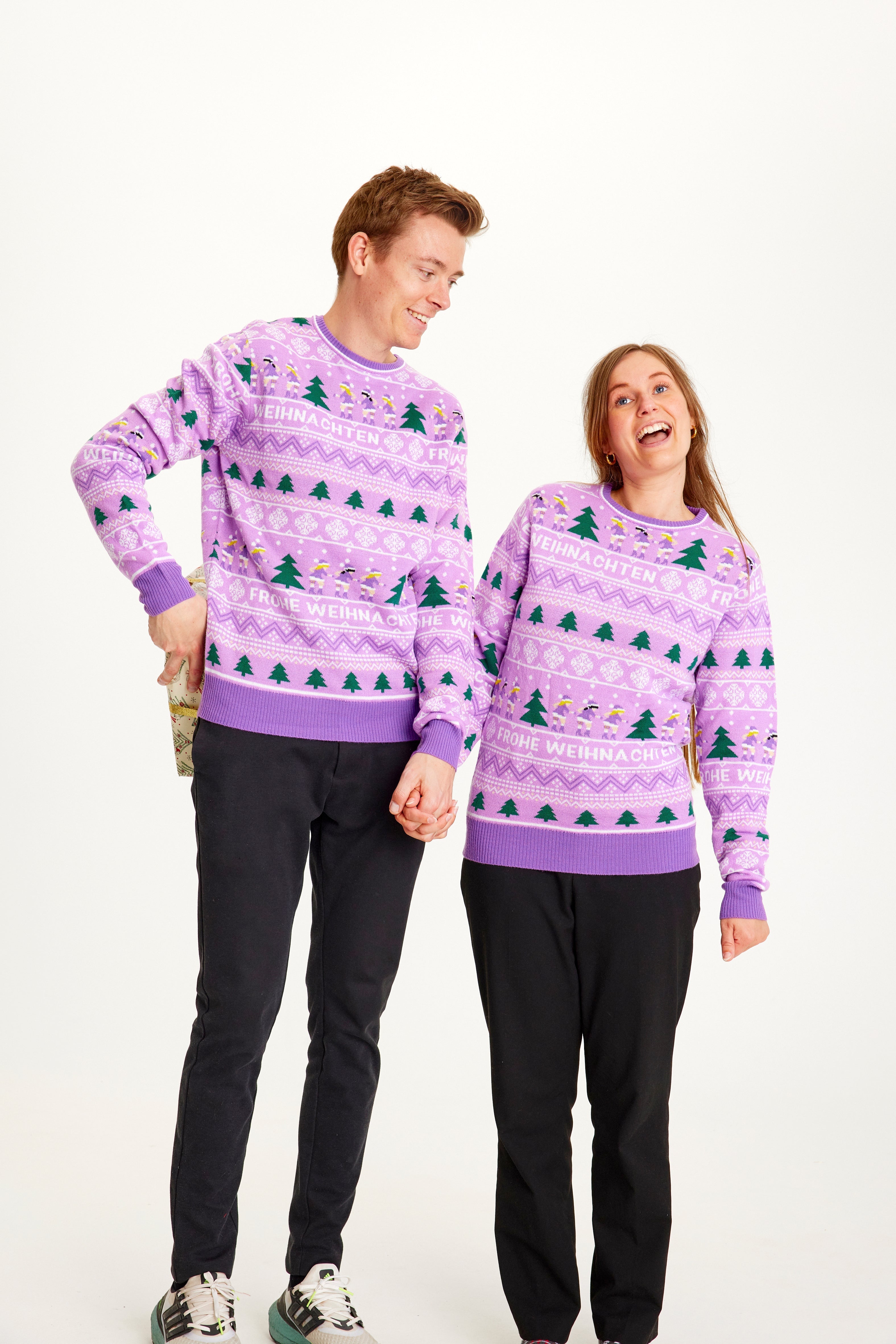 En mand og en dame i samme lilla julesweater.