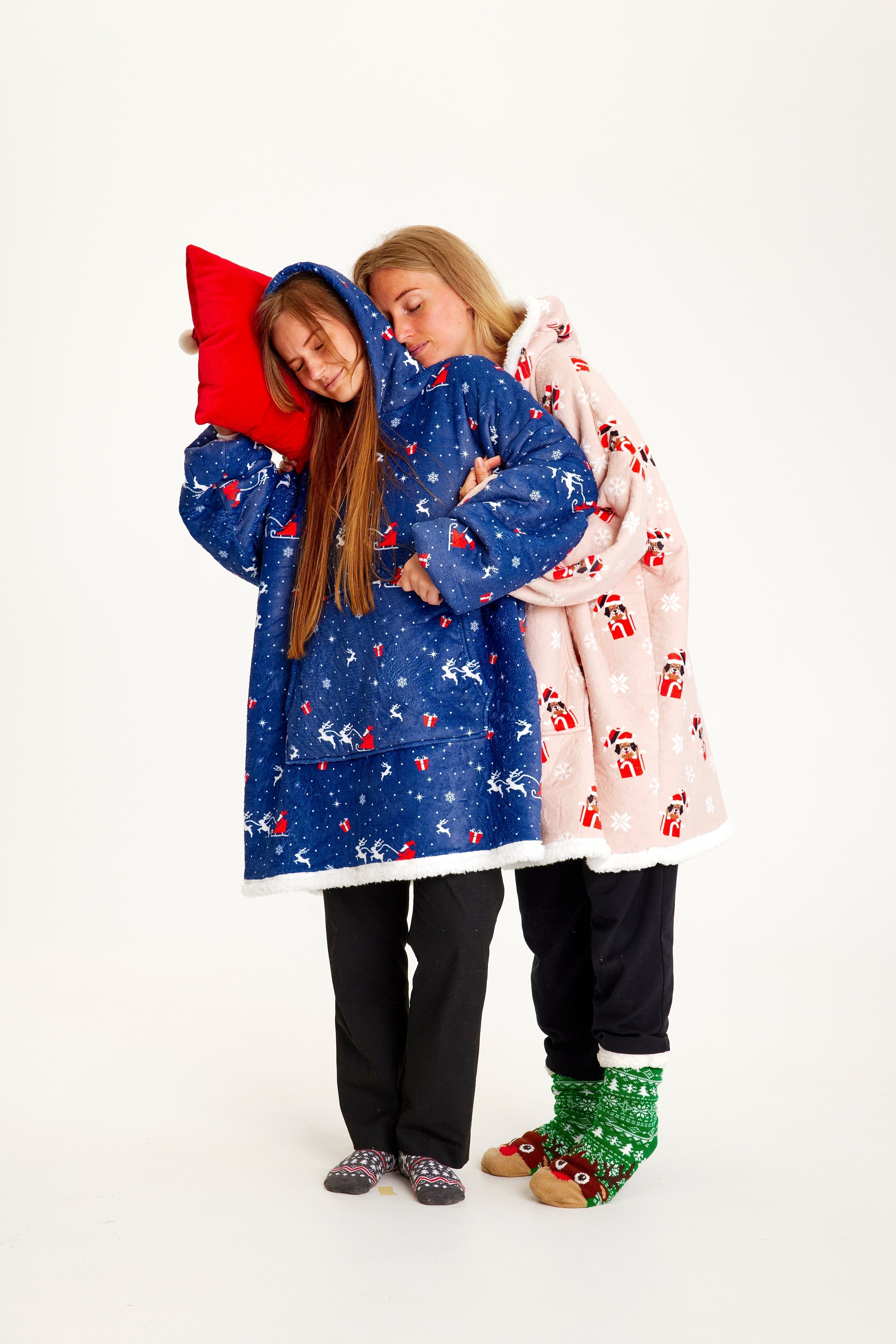 Deux femmes portant un sweat de Noël bleu.